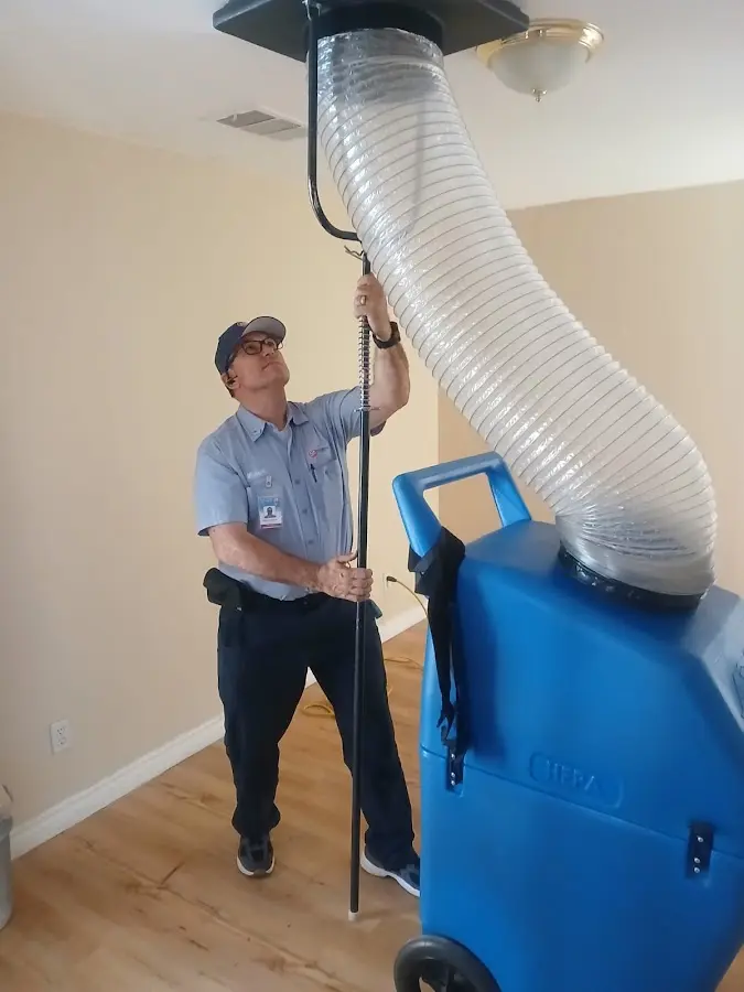 Furnace Tune-Up technician using HEPA equipment in San Antonio